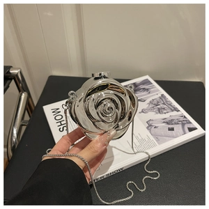 Detailed macro view of the 3D silver rose petal design on the acrylic evening handbag