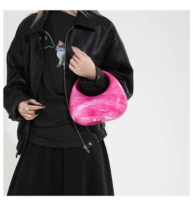 Close-up of pink marble acrylic handbag with smooth glossy finish and hobo style