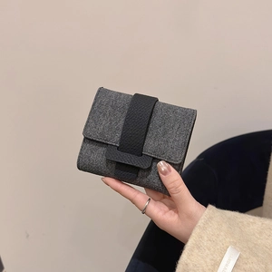 Minimalist grey denim texture tri-fold women's wallet with black leather clasp closure