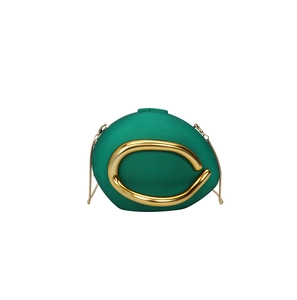 Detail of emerald green round evening bag with large gold C-clasp and delicate chain