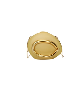 Close-up of mustard yellow egg-shaped crossbody bag with gold U-shaped metal ring