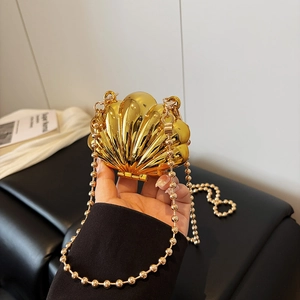 Golden shell-shaped mini crossbody bag with metallic mirror finish and pearl chain strap