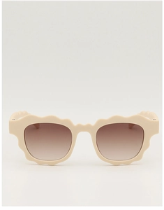 Detail of cream wavy frame children's sunglasses with brown gradient lenses