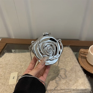 Silver flower shaped acrylic clutch bag with a metallic finish and crossbody chain