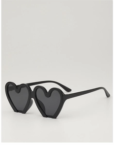 Close-up of stylish black heart-shaped kids sunglasses with dark grey lenses