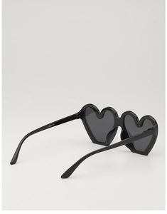 Close-up of heart-shaped kids sunglasses showing model number KD61087 on black temple