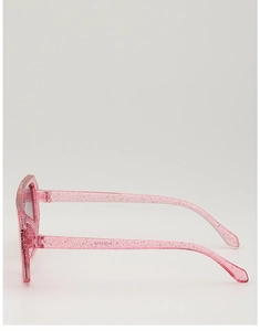 Detail view of pink glitter kids sunglasses featuring transparent frames and metal hinges