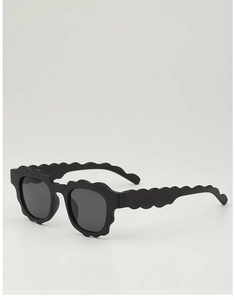 Close-up of wavy scalloped edge sunglasses frame and arms in sleek black finish