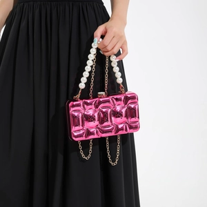Hot pink acrylic wave clutch with large pearl handle and gold chain strap for evening