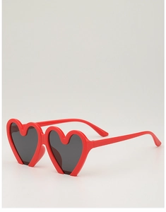 Detailed view of red heart-shaped kids sunglasses with dark protective lenses