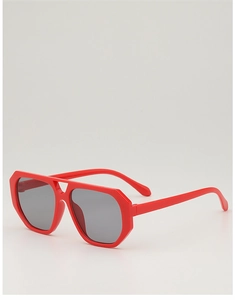 Macro view of bold red aviator sunglasses with thick geometric frames and dark lenses