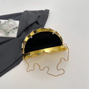 Modern gold shell-shaped evening clutch bag with geometric metal texture and chain