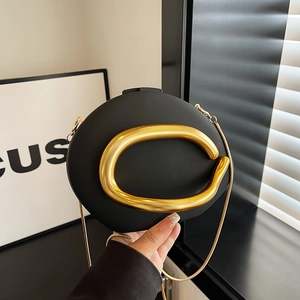 Chic black matte oval clutch bag with golden C-handle and delicate chain strap