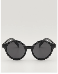 Close-up of black round children sunglasses with a unique wavy textured frame design