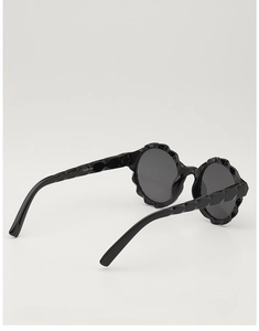 Detail view of round black kids sunglasses with petal-shaped geometric frame and KD51064 code