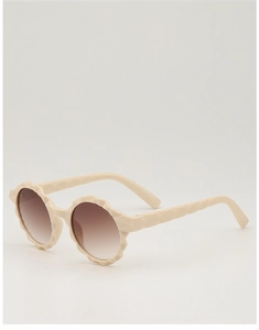 Detail view of round flower-shaped children sunglasses with cream frame and brown lenses