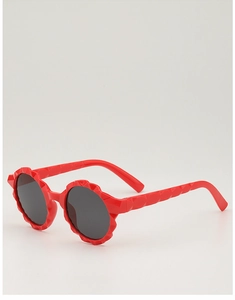Detail of red round faceted children sunglasses with black lenses and geometric frame