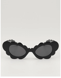 Macro view of black square kids sunglasses featuring unique stylish wavy frame edges