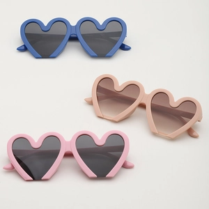 Stylish heart-shaped sunglasses for kids in blue, pink and beige with dark lenses