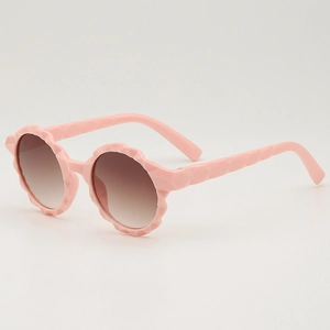 Pink round frame kids sunglasses with geometric texture and brown gradient lenses