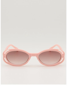 Detail of pink oval sunglasses featuring intricate hollow-out floral patterns on the frames