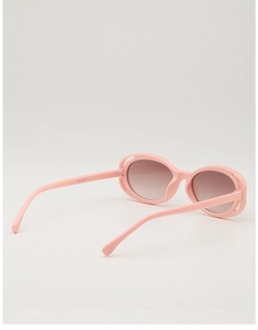 Detailed close-up of pink oval sunglasses frame with brown gradient lenses on white background