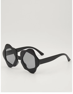 Detail of flower-shaped kids' sunglasses with black floral frames and dark lenses