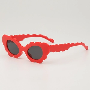 Red flower shaped sunglasses for kids with wavy petal frames and dark gray lenses