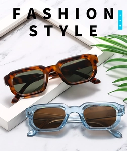 Detail of vintage square sunglasses in tortoiseshell and blue on marble surface