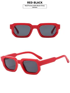 Detail view of red square sunglasses with black grey lenses and wide temples