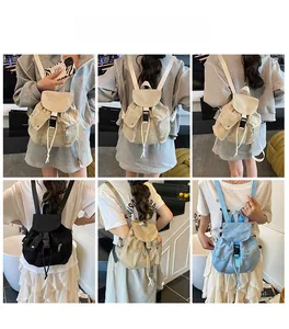 Detail view of canvas backpack in beige, black, and blue with buckle and drawstring closure