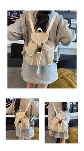 Detail view of beige canvas backpack featuring buckle closure and multiple storage pockets