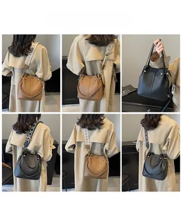 Detail view of vintage bucket bags in brown and black with ethnic style wide straps