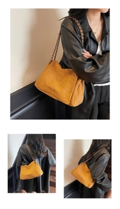 Detail view of mustard suede shoulder bag with chain strap and large storage capacity