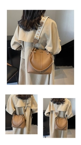 Detail of brown litchi pattern bucket bag with ethnic geometric wide shoulder strap