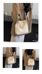 Macro view of beige lychee grain leather bucket bag with vertical stitching and metal beads