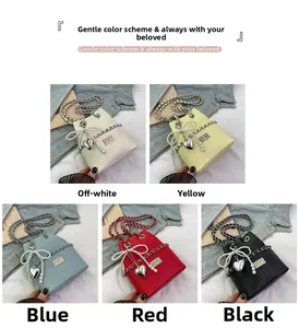 Detail of mini bucket bags with pearl bow, metal chain strap and heart charm accents