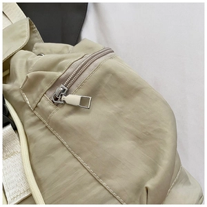 Close-up of casual backpack with durable silver metal zipper and woven strap detail