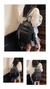 Close-up of black pebble leather backpack with decorative geometric strap and small pouch