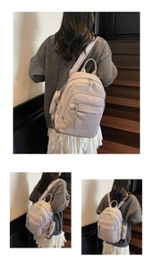 Close-up of soft leather backpack with patterned straps and small side charm