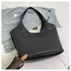 Macro detail of the reinforced bottom stitching on this black matte faux leather handbag