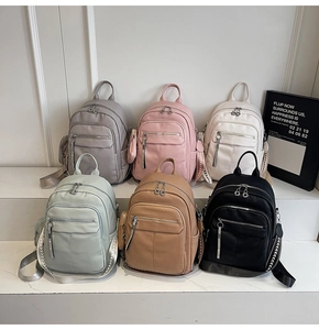Six colors of soft faux leather backpacks displayed with woven straps and multi-pocket design
