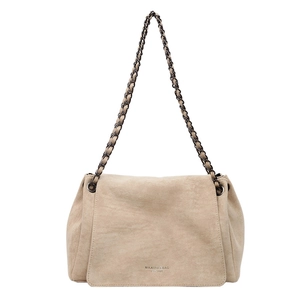 Detail of beige suede shoulder bag with woven chain strap and logo embossed on the flap