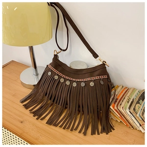 Détail du sac vintage à franges marron avec sangle ethnique et accents de pièces