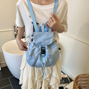 Minimalist light blue nylon backpack with buckle and drawstring closure for daily travel