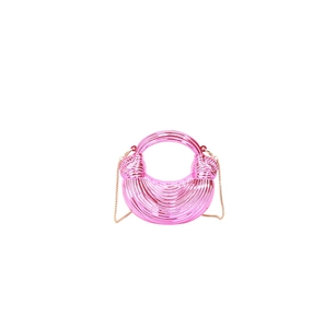 Macro detail of pink metallic mini moon bag showing textured pleats and golden chain strap