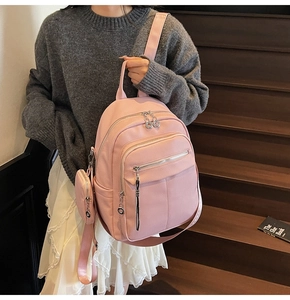 Pink soft leather backpack with lychee grain texture and mini coin purse hanging charm