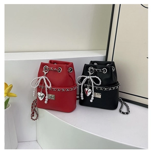 Detail of red and black bucket bags with pearl bows and silver heart charms