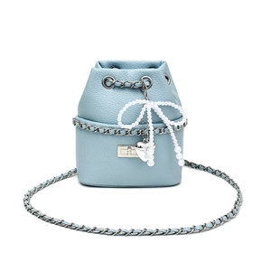 Light blue quilted leather bucket bag with silver chain and pearl bow charm detail