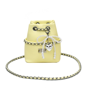 Mini light yellow leather bucket bag with pearl bow, heart pendant and silver chain strap